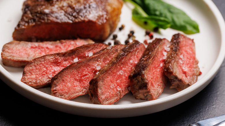 Sliced sirloin steak on a plate.