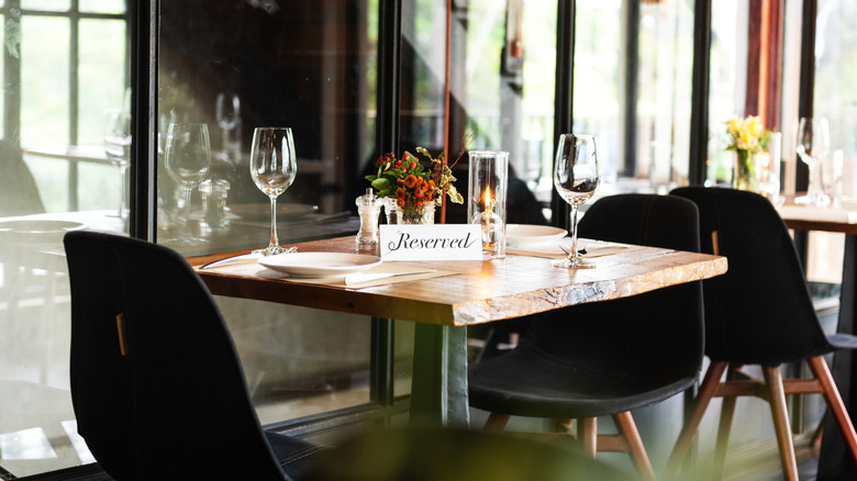 A reserved table with black chairs in a restaurant