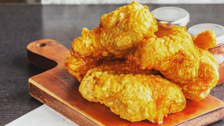 Plain fried wings on a wooden board