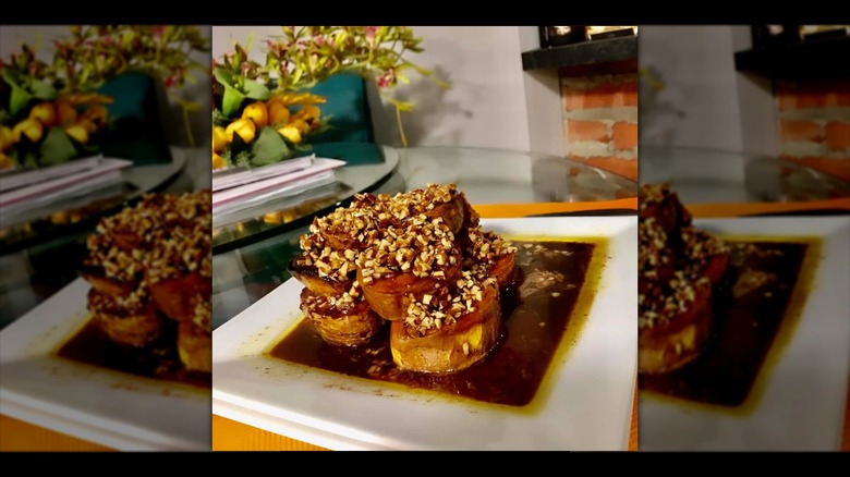 Fondant sweet potatoes topped with chopped pecans