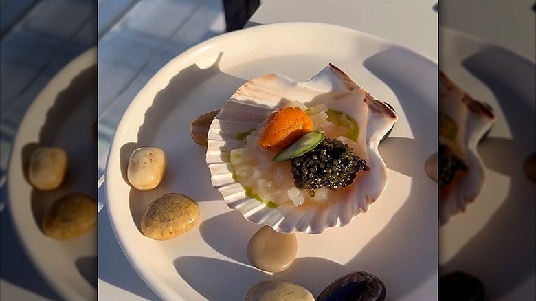 Seafood served in clam shell with black caviar