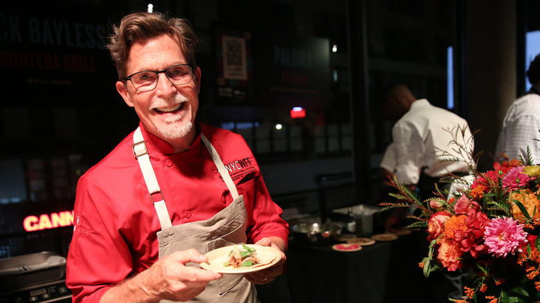Rick Bayless doing a cooking demo in red chef's coat