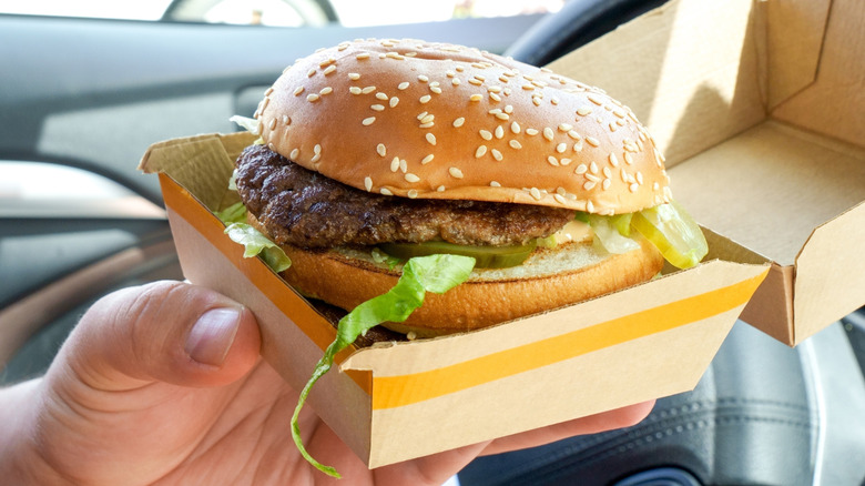 Hand holding McDonald's Big Mac