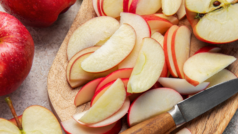 Sliced apples with knife