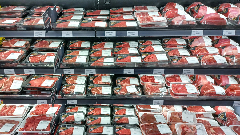 Various meat products in a grocery store aisle