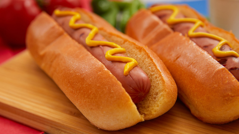 grilled hot dogs in buns with mustard