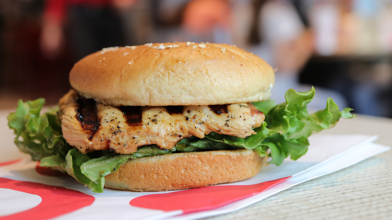 A Chick-fil-A Grilled Chicken Sandwich sits on a table.