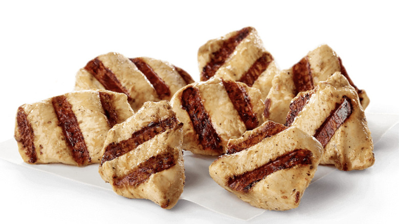 Eight Chick-fil-A Grilled Nuggets sit against a white background.