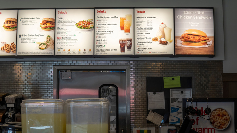 A menu board is hung inside a Chick-fil-A restaurant.