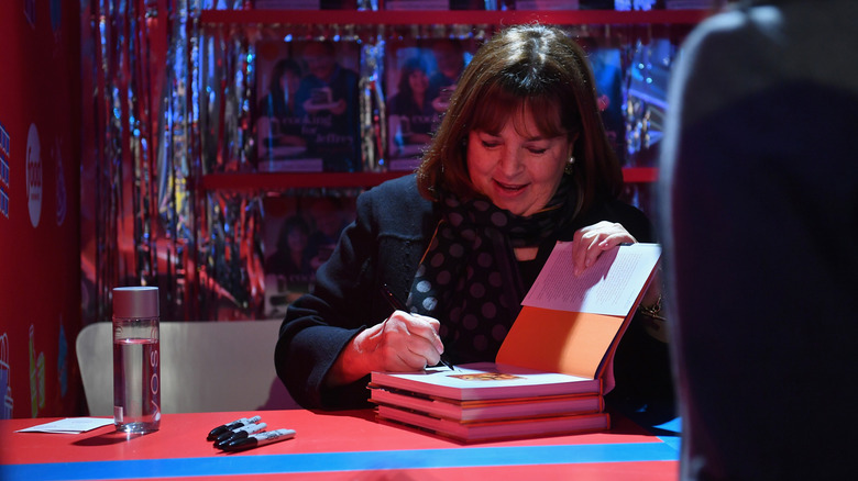 Ina Garten signing a cookbook