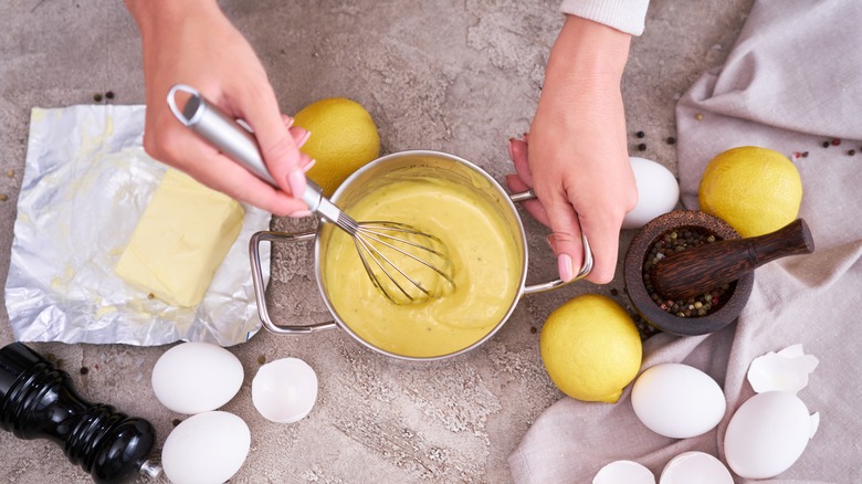 Person whisking hollandaise sauce