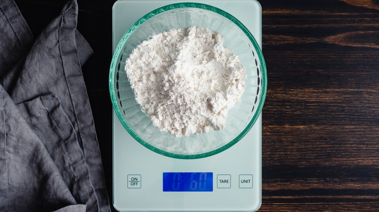 Flour in a bowl, sitting on top of a digital food scale