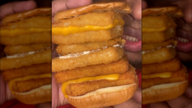 Person holding six-patty Filet-O-Fish