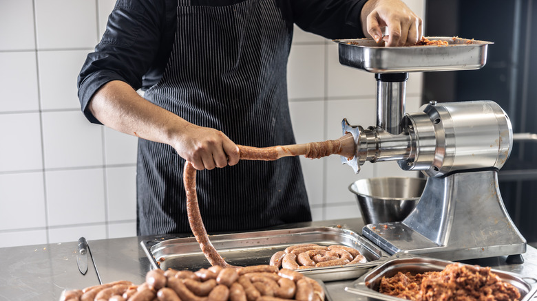 A butcher making sausages.