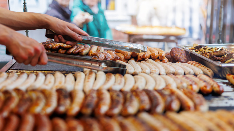 Different types of sausages on a grill.