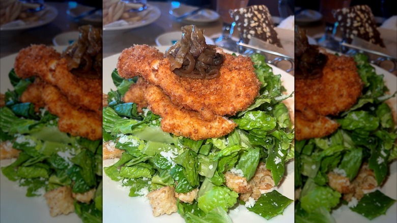 closeup of the viral Louisiana chicken on a Caesar salad