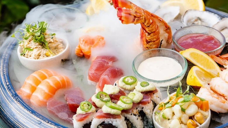 A seafood tower includes lobster, shrimp, and sushi at Rusty Pelican in Miami.