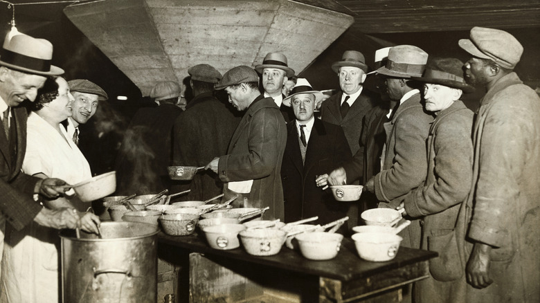 Group of people stand in line for food during the Great Depression