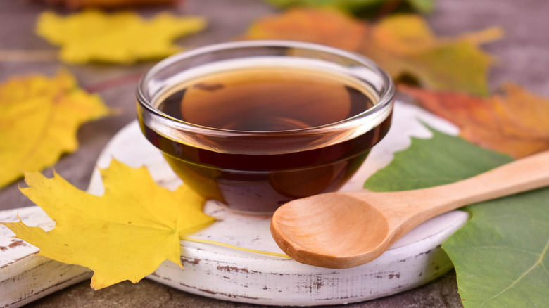 Bowl of maple syrup with maple leaf