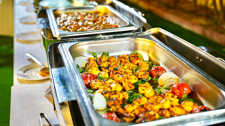 Buffet warming trays filled with meat and vegetables