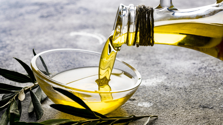 Olive oil being poured into a bowl