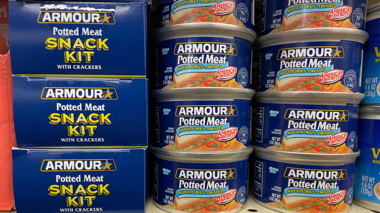 Armour brand potted meat in cans on store shelf.