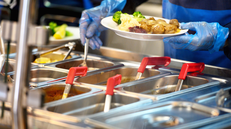 cafeteria plate with serving bowls and ladles