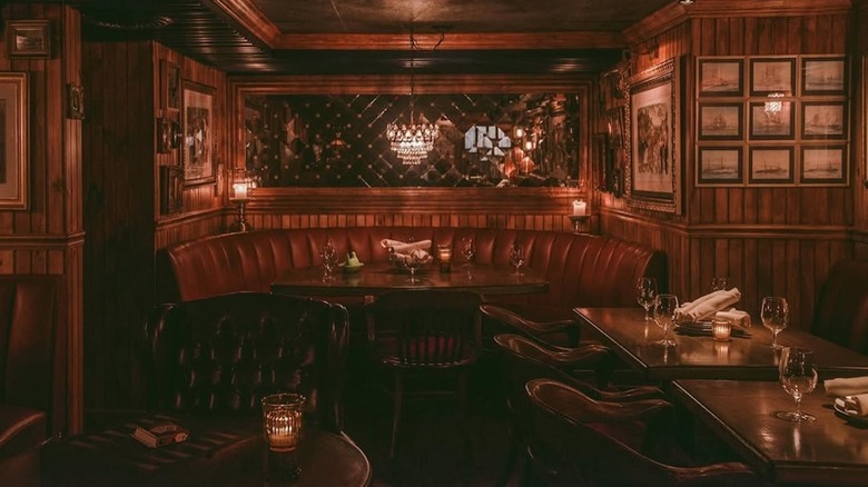 The dining room at 4 Charles Prime Rib is lined in wood with big leather banquettes.