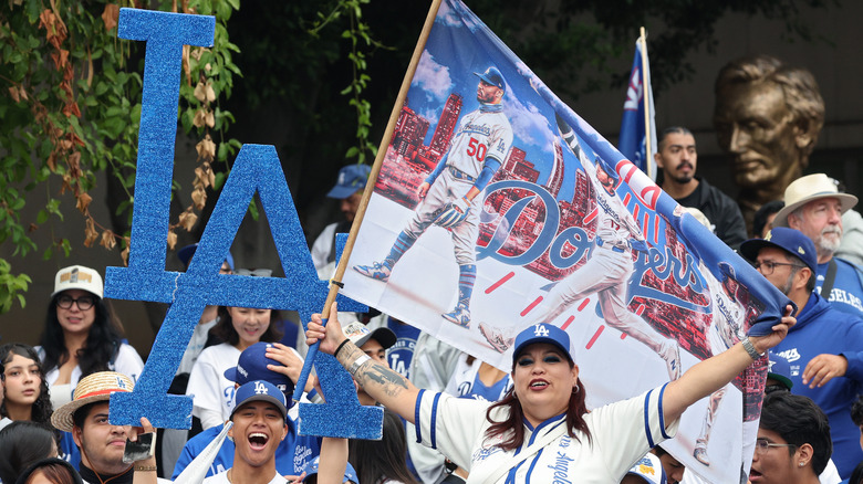 Dodgers fans wear team gear and celebrate a win.