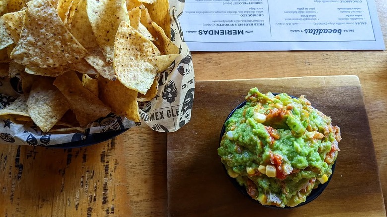 A meal from Momocho consisting of a bowl of guacamole served with a side of tortillas