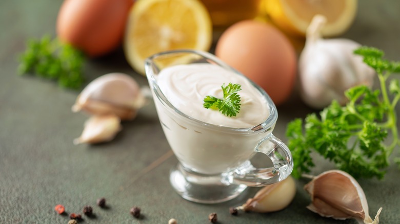 homemade aioli surrounded by lemons, garlic, and eggs