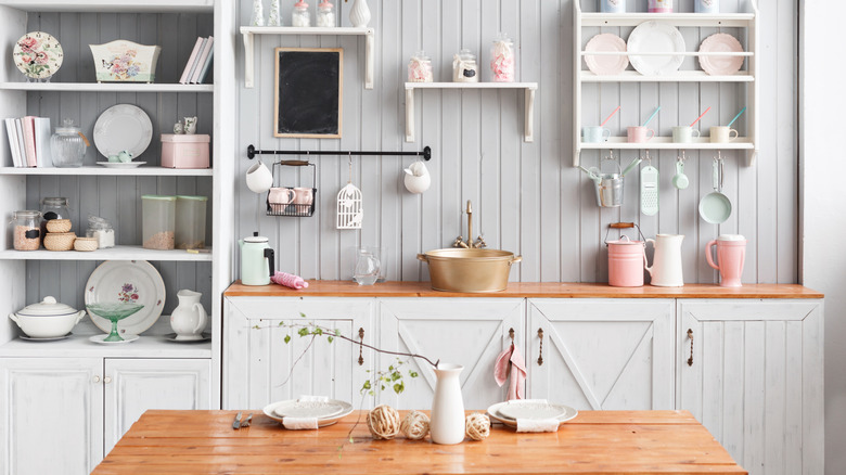 Rustic white kitchen with white wood panel backsplash and wood countertops