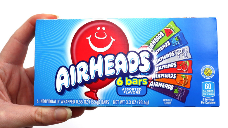 Hand holding a box of Airheads
