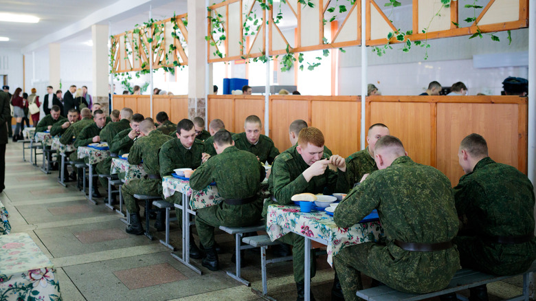 Military soldiers eating a meal.