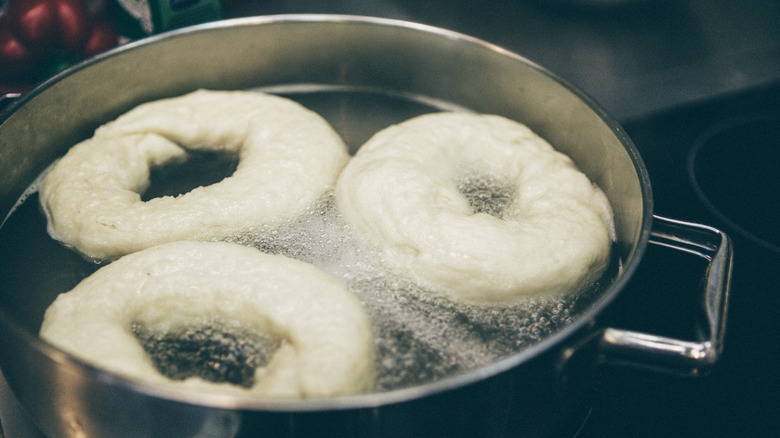 bagels boiling in a pot of water