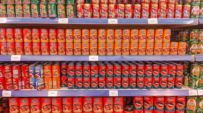 Canned sardines stacked in a grocery store