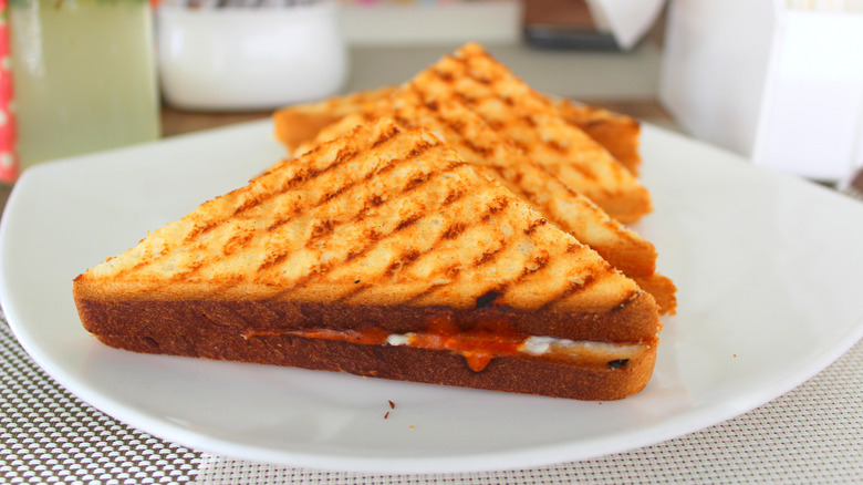A grilled sandwich cut into triangles