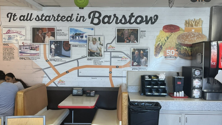 Interior of an Original Del Taco in Barstow with wall art of the restaurant's history