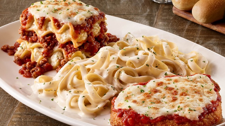 Lasagna, fettucine alfredo, and chicken parmigiana on a white plate