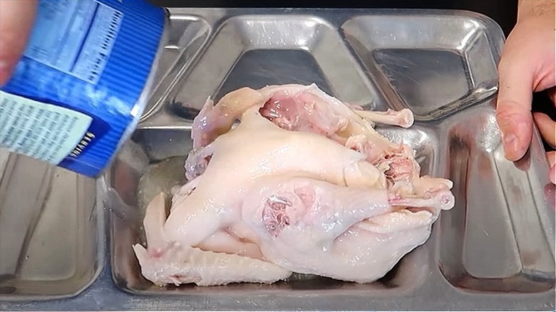 A whole chicken being poured out of a can