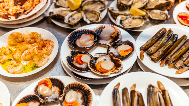 a variety of assorted shellfish stacked on plates