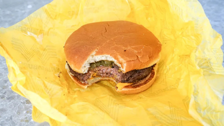 Whataburger's Green Chile Double on top of a yellow branded burger wrapper