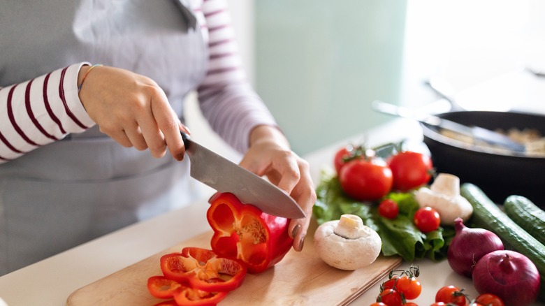 Person chopping veggies with a chef's knife