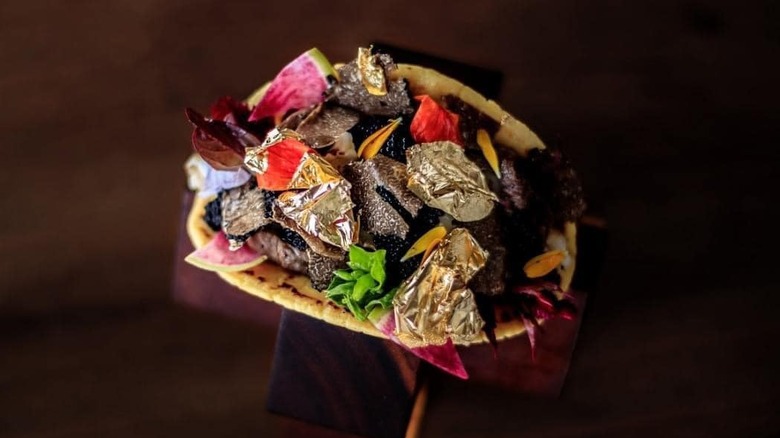Frida's "world's most expensive taco" on wooden stand