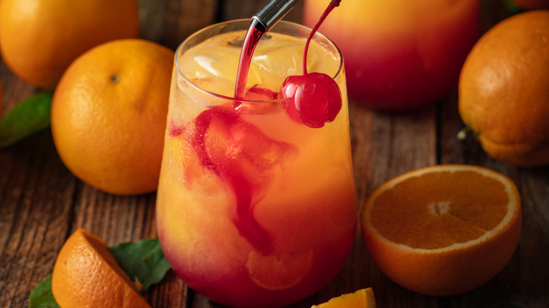 Grenadine pouring into a tequila sunrise