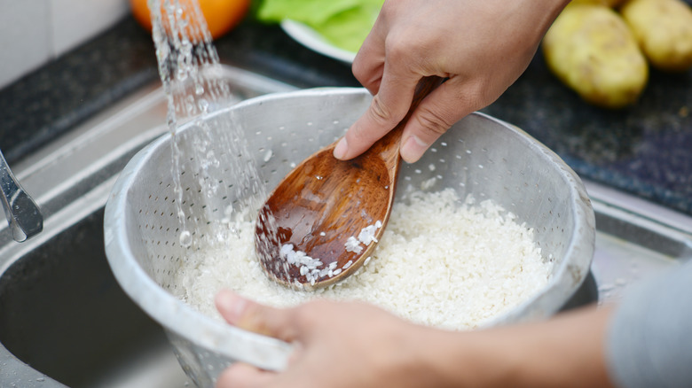 Washing rice in a colander