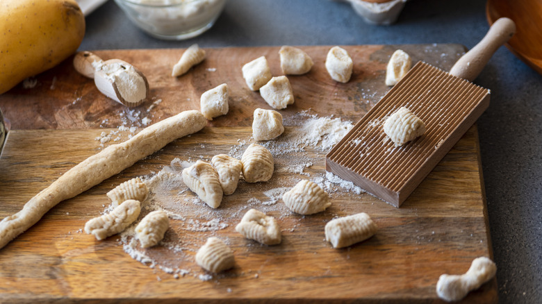 Rolled out gnocchi dough with pieces already cut and rolled.