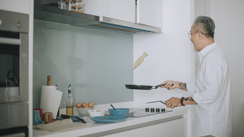 Chef flipping a fried egg