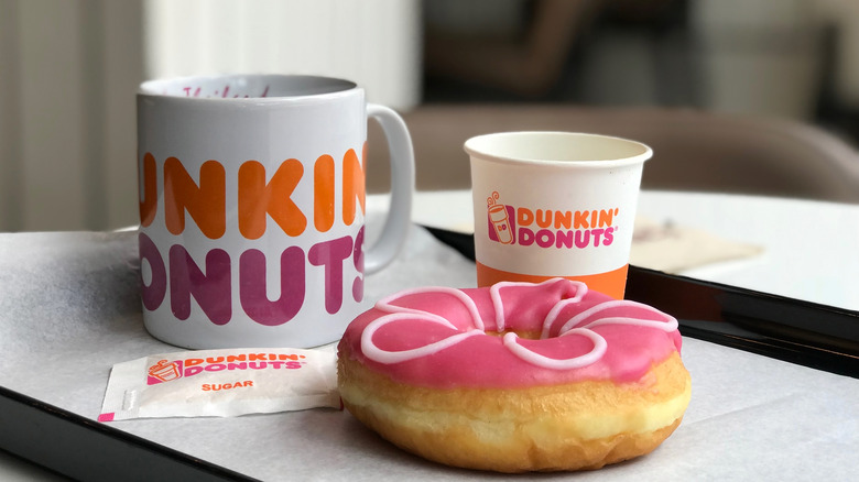 Dunkin coffee and pink donut