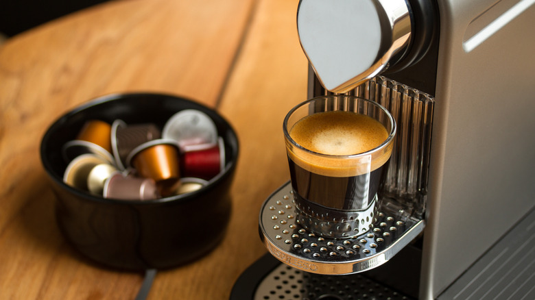 Photo of Nespresso Machine brewing a cup of coffee